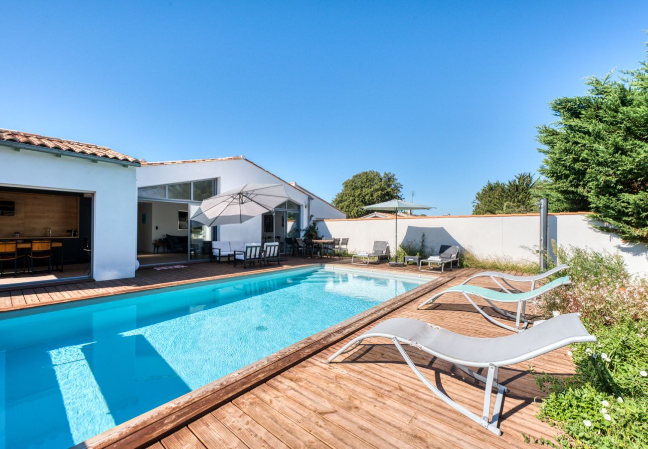 Exterior of Ile de Ré villa with swimming pool deckchair and outdoor shower